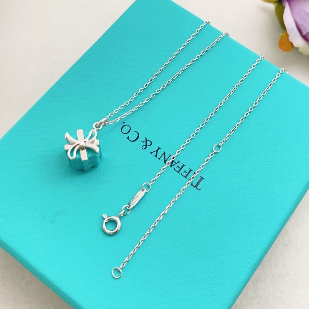 Tiffany & Co. Silver bow-shaped blue perfume bottle necklace